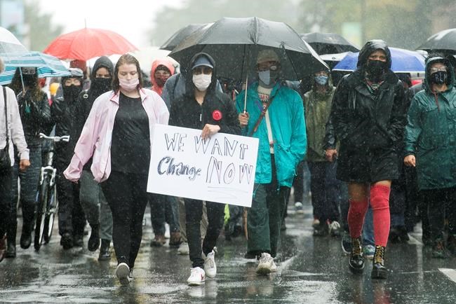 People attend a demonstration in Montreal, Saturday, Aug. 29, 2020, where they protested to defund the police with a goal to end all systemic racism within all sectors of the Canadian government. THE CANADIAN PRESS/Graham Hughes