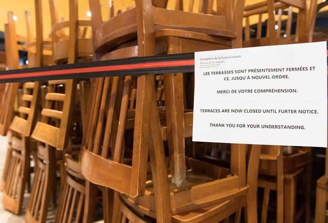 A sign notifying customers of a closed terrace is shown at food court in Montreal, Wednesday, March 18, 2020, as COVID-19 cases rise in Canada and around the world. THE CANADIAN PRESS/Graham Hughes