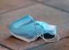 A discarded face mask is shown on the floor of a food court in a shopping mall in Montreal, Saturday, July 18, 2020, as the COVID-19 pandemic continues in Canada and around the world THE CANADIAN PRESS/Graham Hughes