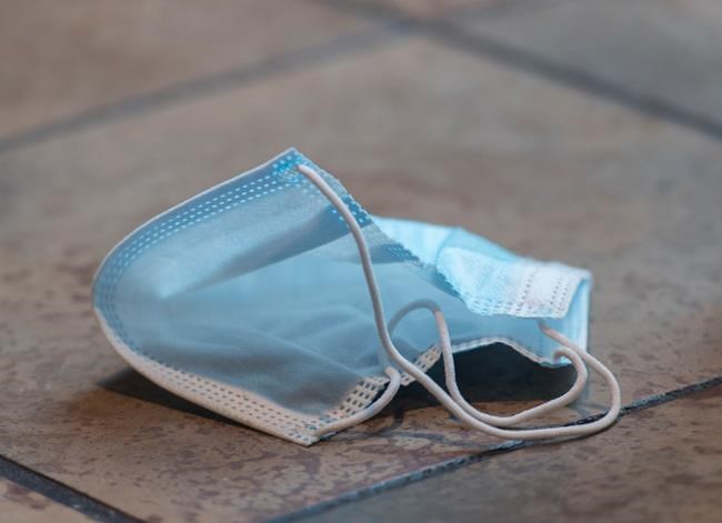 A discarded face mask is shown on the floor of a food court in a shopping mall in Montreal, Saturday, July 18, 2020, as the COVID-19 pandemic continues in Canada and around the world THE CANADIAN PRESS/Graham Hughes