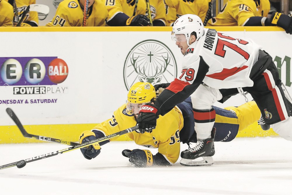 Mark Humphrey / Associated Press files
Hawryluk and Nashville Predators defenceman Roman Josi battle for the puck in a game on Feb. 25 in Nashville, Tenn.