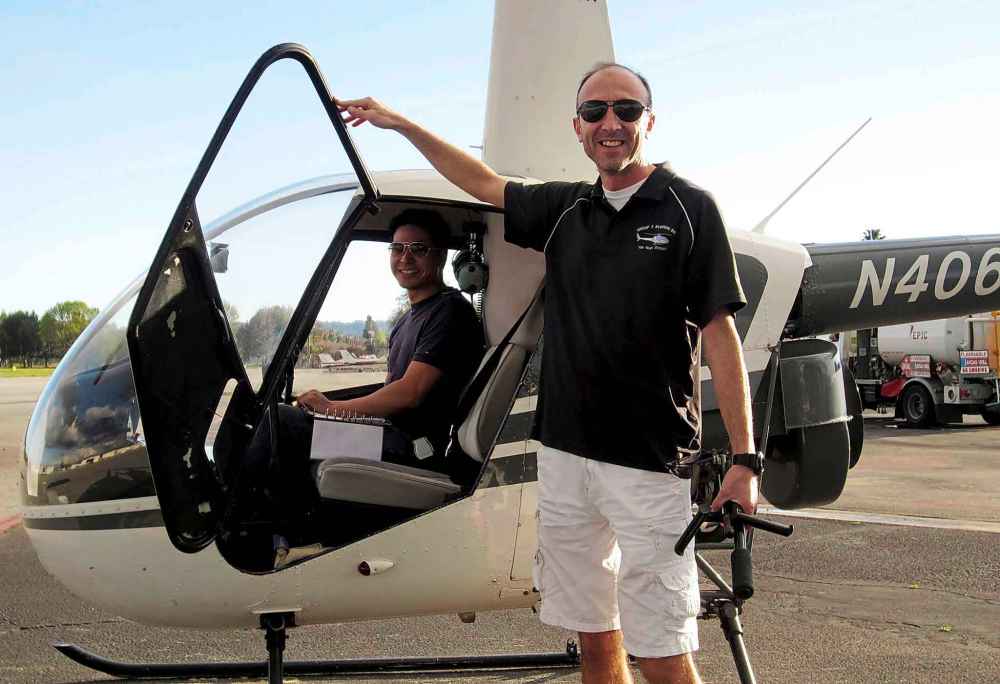 Pilot Ara Zobayan (standing) was flying the helicopter when it went down in heavy fog this past Sunday. (Group 3 Aviation)