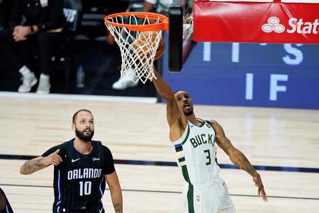Milwaukee Bucks' George Hill (3) drives to the basket past Orlando Magic's Evan Fournier (10) during the second half of an NBA basketball first round playoff game Monday, Aug. 24, 2020, in Lake Buena Vista, Fla. (AP Photo/Ashley Landis, Pool)