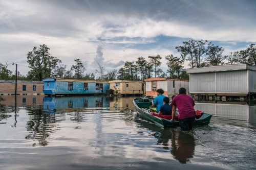 The Maldonado family travel by boat to their home after it flooded during Hurricane Ida, on Tuesday in Barataria, La. (Brandon Bell / Getty Images/TNS)
