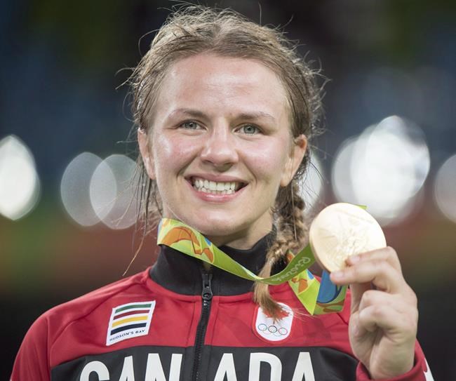 Canada's Erica Wiebe, from Stittsville, Ont., displays her gold medal after defeating Kazakhstan's Guzel Manyurova to win their women's 75kg freestyle wrestling gold medal match at the 2016 Summer Olympics in Rio de Janeiro, Brazil on August 18, 2016. Canadian athletes quickly began recalibrating their lives Tuesday when the International Olympic Committee stated the Tokyo Games will be postponed until 2021. That development came less than 48 hours after the Canadian Olympic and Paralympic committees declared they would not send teams to Tokyo this summer.