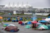 A man walks through a homeless camp where approximately 150 people are living at a parking lot on Port of Vancouver property adjacent to Crab Park, in Vancouver on June 10, 2020. A new report on women's homelessness in Canada reveals the number of women experiencing homelessness in Canada is dramatically underestimated. The study, led by the Women's National Housing & Homelessness Network, has found homelessness among women, especially for vulnerable populations, is made invisible by how it is defined, measured and how societies respond to housing needs. The federal government has provided funding to women's shelters as part of its response to the COVID-19 pandemic, but the report calls on Canada to take a more gender-sensitive approach to homelessness to stop large numbers of women from returning to violent and precarious situations. THE CANADIAN PRESS/Darryl Dyck