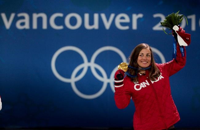 Canada's Maelle Ricker celebrates her gold medal win for snowboard cross during a medal ceremony at the 2010 Winter Olympic Games in Vancouver on February 17, 2010. THE CANADIAN PRESS/Jonathan Hayward