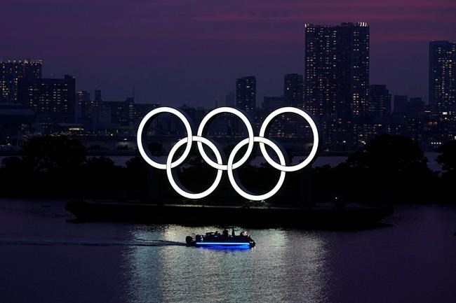 The Olympic rings float in the water at sunset in the Odaiba section of Wednesday, June 3, 2020, in Tokyo. The Canadian Centre for Ethics in Sport says it supports freedom of expression for athletes at Olympic and Paralympic Games. The CCES, which administers Canada's anti-doping program and advocates for ethical sport, is calling upon the International Olympic Committee to amend Rule 50 of the Olympic charter. THE CANADIAN PRESS/AP, Eugene Hoshiko
