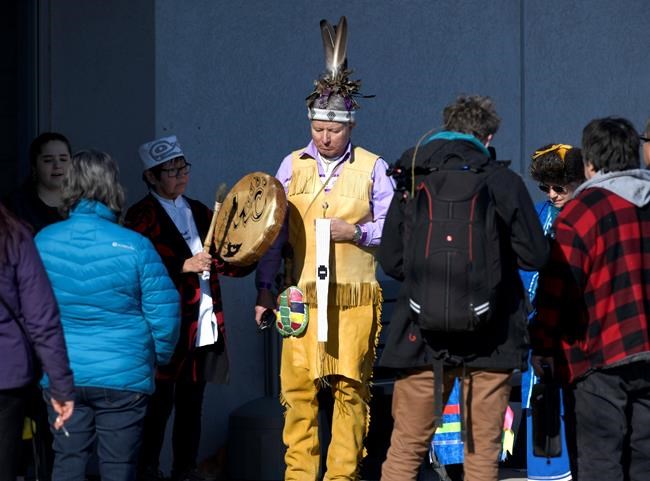 Wet'suwet'en hereditary chiefs are welcomed by members of the Mohawk People's Council before entering the Mohawk Community Centre for a meeting on Thursday Feb. 20, 2020, in Tyendinaga Mohawk Territory near Belleville, Ont., on Friday, Feb. 21, 2020, in the midst of a blockade on a nearby rail line in solidarity with Wet'suwet'en hereditary chiefs opposed to the Coastal GasLink pipeline in northern British Columbia. THE CANADIAN PRESS/Justin Tang