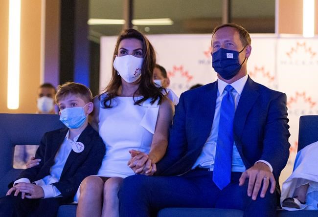 Peter MacKay, leadership candidate for the Conservative Party of Canada, watches a broadcast show that will announce the party's new leader with his wife Nazanin Afshin-Jam MacKay and son Kian, 7, in Ottawa on Sunday, Aug. 23, 2020. THE CANADIAN PRESS/Justin Tang