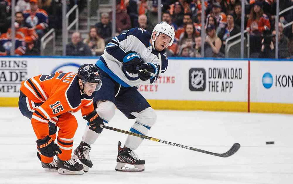 THE CANADIAN PRESS/Jason Franson
Winnipeg Jets' Dmitry Kulikov and Edmonton Oilers' Josh Archibald battle for the puck during the first period.