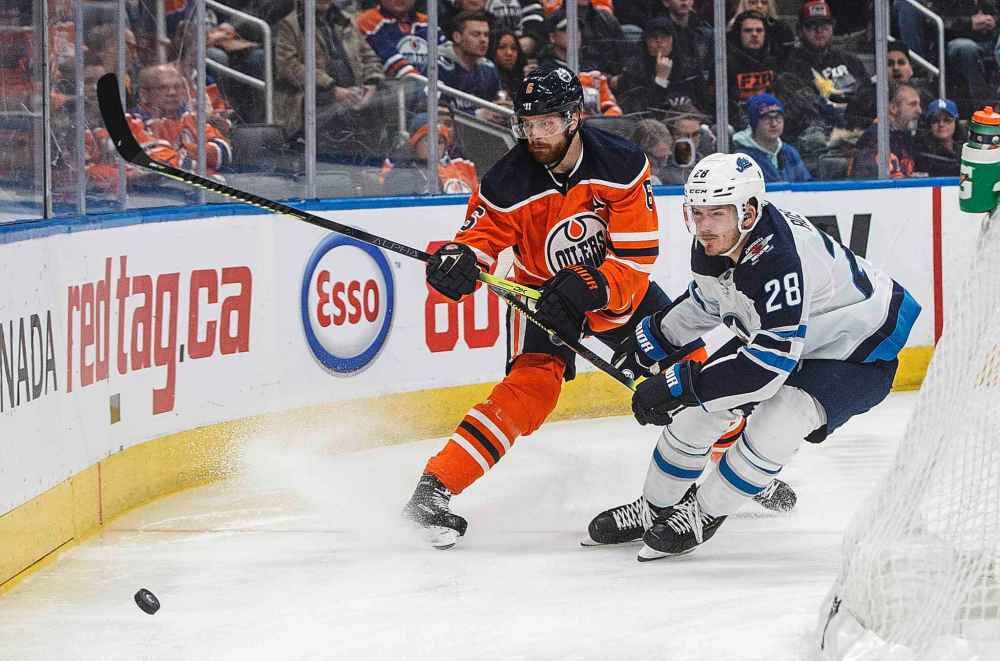 THE CANADIAN PRESS/Jason Franson
Winnipeg Jets' Jack Roslovic and Edmonton Oilers' Adam Larsson battle for the puck during the first period.