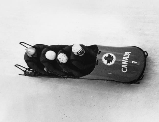 The Canadian four man bobsled team in the Winter Olympic event in the third run at Igls, Austria, Feb. 6, 1964. Front to back; Piloted by Victor Emery, Douglas Anakin, John Emery, and Peter Kirby. Douglas Anakin, who helped Canada win Olympic bobsled gold in 1964, has died at age 89. Anakin, Peter Kirby and brothers John and Vic Emery claimed four-man gold at the 1964 Winter Olympics in Innsbruck, Austria. THE CANADIAN PRESS/ file