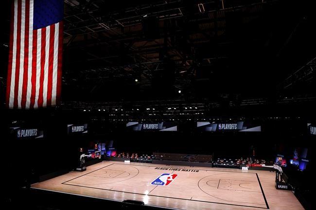 An empty court and bench are shown with no signage following the scheduled start time in Game 5 of an NBA basketball first-round playoff series, Wednesday, Aug. 26, 2020, in Lake Buena Vista, Fla. The professional sports schedule is expected to start getting busier on Friday after a string of postponements the past two days, but it won't be back to normal just yet. THE CANADIAN PRESS/AP, Kevin C. Cox/Pool Photo