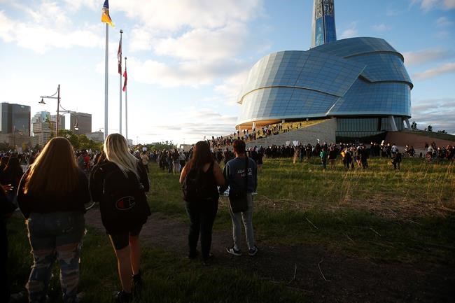 People gather in solidarity with the George Floyd protests across the United States at the Canadian Museum for Human Rights in Winnipeg, Friday, June 5, 2020. The museum and its morals have been recently questioned after numerous Black and Indigenous current and former employees shared stories of racism, descrimination and censorship. THE CANADIAN PRESS/John Woods