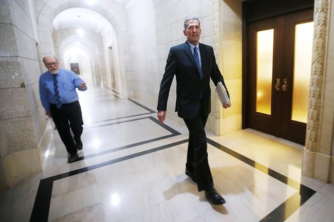 Manitoba Premier Brian Pallister does not respond to a reporter's question as he makes his way to question period at the Manitoba Legislature in Winnipeg, Wednesday, May 13, 2020. THE CANADIAN PRESS/John Woods