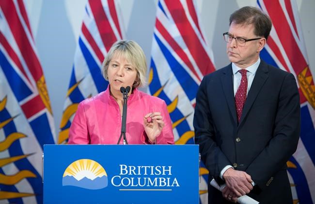 British Columbia Health Minister Adrian Dix looks on as Provincial Health Officer Dr. Bonnie Henry addresses the media during a news conference at the BC Centre of Disease Control in Vancouver B.C, Tuesday, January 28, 2020. Dix and Dr. Henry announced Tuesday that British Columbia has confirmed its first case of coronavirus and the person in question is being treated. THE CANADIAN PRESS/Jonathan Hayward