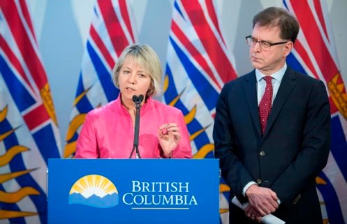 British Columbia Health Minister Adrian Dix looks on as Provincial Health Officer Dr. Bonnie Henry addresses the media during a news conference at the BC Centre of Disease Control in Vancouver B.C, Tuesday, January 28, 2020. Dix and Dr. Henry announced Tuesday that British Columbia has confirmed its first case of coronavirus and the person in question is being treated. THE CANADIAN PRESS/Jonathan Hayward