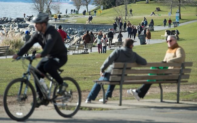 People are seen in English Bay in Vancouver, B.C. Tuesday, March 24, 2020. THE CANADIAN PRESS/Jonathan Hayward