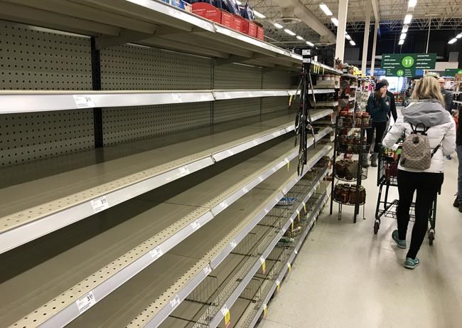 Near empty shelves are pictured at a grocery store in North Vancouver, B.C. Saturday, March 14, 2020. THE CANADIAN PRESS/Jonathan Hayward