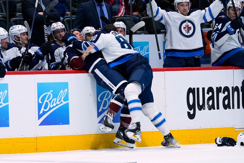 CP
Pierre-Luc Dubois knocks Colorado's Logan O'Connor into the bench during a 7-1 loss to the Avalanche on Jan. 6. (Jack Dempsey / The Associated Press)