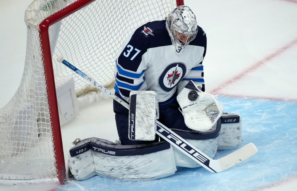 CP
Winnipeg Jets goaltender Connor Hellebuyck makes a glove-save in the first period of an NHL hockey game against the Colorado Avalanche, Friday, Feb. 25, 2022, in Denver. (AP Photo/David Zalubowski)