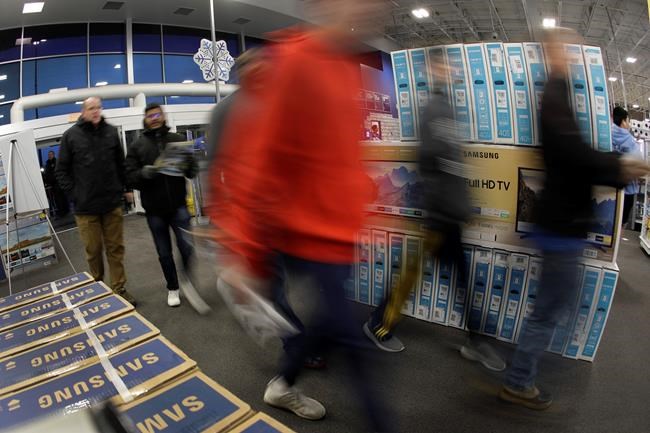 Shoppers enter a Best Buy store for a Black Friday sale Thursday, Nov. 28, 2019, in Overland Park, Kan. (AP Photo/Charlie Riedel)