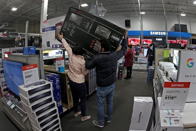 People shop at a Best Buy store during a Black Friday sale Thursday, Nov. 28, 2019, in Overland Park, Kan. (AP Photo/Charlie Riedel)