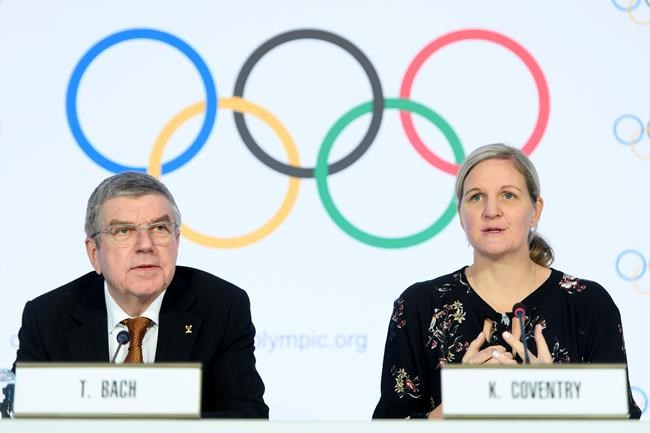 International Olympic Committee (IOC) president Thomas Bach, left, and IOC member and former swimmer Kirsty Coventry, right, speak during a press conference after the executive board meeting of the IOC, at the Olympic House, in Lausanne, Switzerland, Thursday, Jan. 9, 2020. (Laurent Gillieron/Keystone via AP)