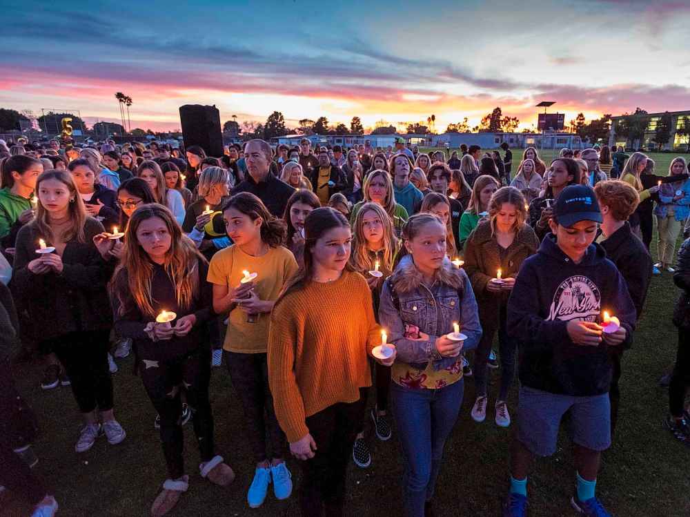 People gather for a candlelight vigil for Alyssa Altobelli and her parents in Newport Beach, Calif. on Thursday. Alyssa and her parents, John and Keri Altobelli, were among the nine who died in Sunday's helicopter crash in Calabasas. (Leonard Ortiz / The Orange County Register)