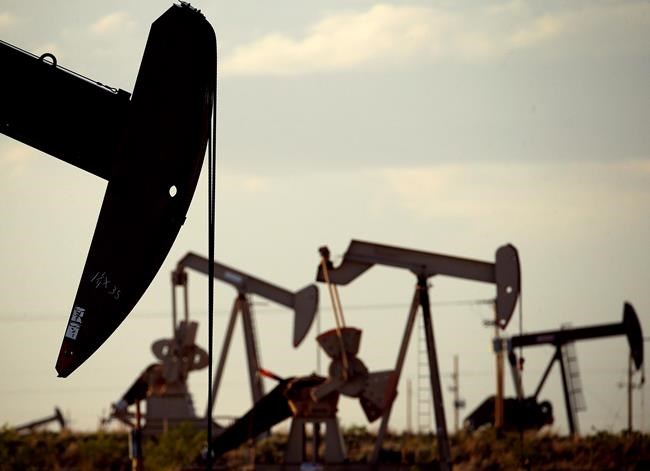 FILE - In this April 24, 2015, file photo, pumpjacks work in a field near Lovington, N.M. In the closing months of the Trump administration, energy companies stockpiled enough drilling permits for western public lands to keep pumping oil for years. That stands to undercut President-elect Joe Biden's plans to block new drilling on public lands to address climate change. (AP Photo/Charlie Riedel, File)