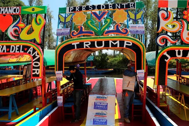 FILE - In this Nov. 1, 2020 file photo people stick flyers in a chinampa in support of the reelection of President Donald Trump, in the Xochimilco district of Mexico City. Mexico's economy is forecast to contract nearly 10% this year -- the biggest decline in the region -- and President Andrés Manuel López Obrador knows any chance of climbing out of that hole will depend greatly on a rapid U.S. economic recovery. Perhaps more important than who wins the White House will be a clear result and stability for its neighbor to the north, since the U.S. and Mexico are each other's biggest trade partners. (AP Photo/Ginnette Riquelme, File)