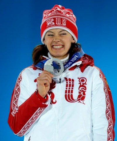 FILE - In this Monday, Feb. 10, 2014 file photo, women's 7.5K sprint silver medalist Olga Vilukhina of Russia smiles with her medal during the medals ceremony at the 2014 Winter Olympics, in Sochi, Russia. Two-time Olympic biathlon champion Olga Zaitseva lost her appeal Thursday Sept. 24, 2020, against disqualification from the 2014 Sochi Olympics for her part in Russia’s state-backed doping program and two of Zaitseva’s relay teammates at Sochi, Olga Vilukhina and Yana Romanova, won their appeals and had their IOC disqualifications from individual biathlon events at Sochi overturned. (AP Photo/Morry Gash, File)