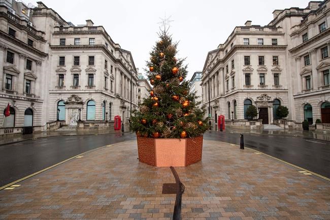 A quiet Lower Regent Street, in London on Monday Dec. 21, 2020. Millions of people in England have learned they must cancel their Christmas get-togethers and holiday shopping trips. British Prime Minister Boris Johnson said Saturday that holiday gatherings can’t go ahead and non-essential shops must close in London and much of southern England. (Dominic Lipinski/PA Wire(/PA via AP)