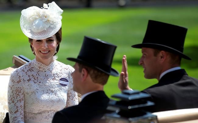 FILE - In this Tuesday, June 20, 2017 file photo, Britain's Kate, Duchess of Cambridge, left, smiles as she travels with Prince William, right, and Prince Edward in a open carriage to the parade ring on the first day of the Royal Ascot horse race meeting in Ascot, England. Prince Philip was the longest serving royal consort in British history. In Britain, the husband or wife of the monarch is known as consort, a position that carries immense prestige but has no constitutional role. The wife of King George VI, who outlived him by 50 years, was loved as the Queen Mother. Prince Charles’ wife, Camilla, has worked to emerge from the shadow of his immensely popular first wife, Diana. (AP Photo/Alastair Grant, File)
