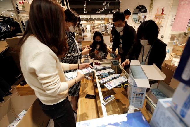 Lee Jin-man / The Associated Press
Employees of a department store prepare to sell face masks at a department store in Seoul, South Korea, Friday, Feb. 28, 2020. Countries take harsh containment steps as a new virus spreads. (AP Photo/Lee Jin-man)