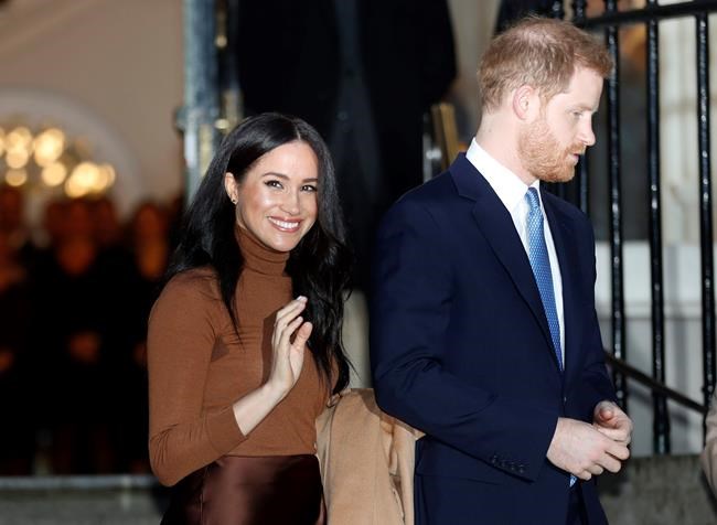 FILE - In this Jan. 7, 2020, file photo, Britain's Prince Harry and Meghan, Duchess of Sussex leave after visiting Canada House in London, after their recent stay in Canada. Prince Harry and Meghan Markle are to no longer use their HRH titles and will repay £2.4 million of taxpayer's money spent on renovating their Berkshire home, Buckingham Palace announced Saturday, Jan. 18. 2020. (AP Photo/Frank Augstein, File)