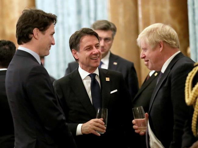 Britain's Prime Minister Boris Johnson talks to Canadian Prime Minister Justin Trudea left, and Italian Prime Minister Guiseppe Conte during a reception at Buckingham Palace, as NATO leaders gather to mark 70 years of the alliance, in London, Tuesday, Dec. 3, 2019. U.S. President Donald Trump and his NATO counterparts were gathering in London Tuesday to mark the alliance's 70th birthday amid deep tensions as spats between leaders expose a lack of unity that risks undermining military organization's credibility. (Yui Mok/Pool Photo via AP)