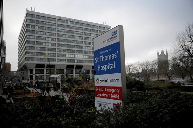 A welcome sign is displayed outside St Thomas' Hospital, with the Houses of Parliament in the background at right, in London, which starting this week is going to be one of the hubs for vaccinating people in Britain against coronavirus, Monday, Dec. 7, 2020. Shipments of the coronavirus vaccine developed by American drugmaker Pfizer and Germany's BioNTech were delivered Sunday in the U.K. in super-cold containers, two days before it goes public in an immunization program that is being closely watched around the world. (AP Photo/Matt Dunham)