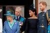 FILE - In this Tuesday, July 10, 2018 file photo Britain's Queen Elizabeth II, Prince Andrew, Meghan the Duchess of Sussex and Prince Harry stand on a balcony to watch a flypast of Royal Air Force aircraft pass over Buckingham Palace in London. As part of a surprise announcement distancing themselves from the British royal family, Prince Harry and his wife Meghan declared they will 