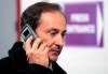 FILE - In this file photo dated Friday, Jan. 20, 2006, former President of the French Federation of Figure Skating Didier Gailhaguet speaks on his cell phone at the European Figure Skating Championships at the Palais des Sports ice rink in Lyon, central France. The head of the French skating federation Didier Gailhaguet has been summoned for a meeting with the country's sports minister following a string of accusations of sexual abuse against the sport coach Gilles Beyer. (AP Photo/Francois Mori, FILE)