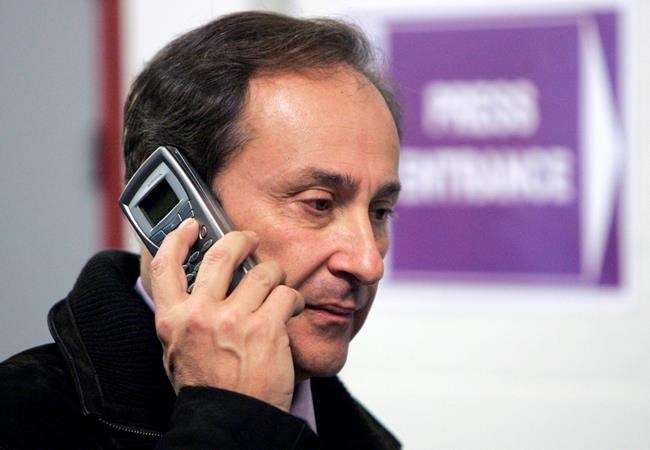 FILE - In this file photo dated Friday, Jan. 20, 2006, former President of the French Federation of Figure Skating Didier Gailhaguet speaks on his cell phone at the European Figure Skating Championships at the Palais des Sports ice rink in Lyon, central France. The head of the French skating federation Didier Gailhaguet has been summoned for a meeting with the country's sports minister following a string of accusations of sexual abuse against the sport coach Gilles Beyer. (AP Photo/Francois Mori, FILE)