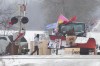 A Protester walk near closed train tracks in Tyendinaga Mohawk Territory near Belleville, Ont. on Tuesday, Feb. 18, 2020, as they protest in solidarity with the Wet'suwet'en hereditary chiefs opposed to the LNG pipeline in northern British Columbia. THE CANADIAN PRESS/Lars Hagberg