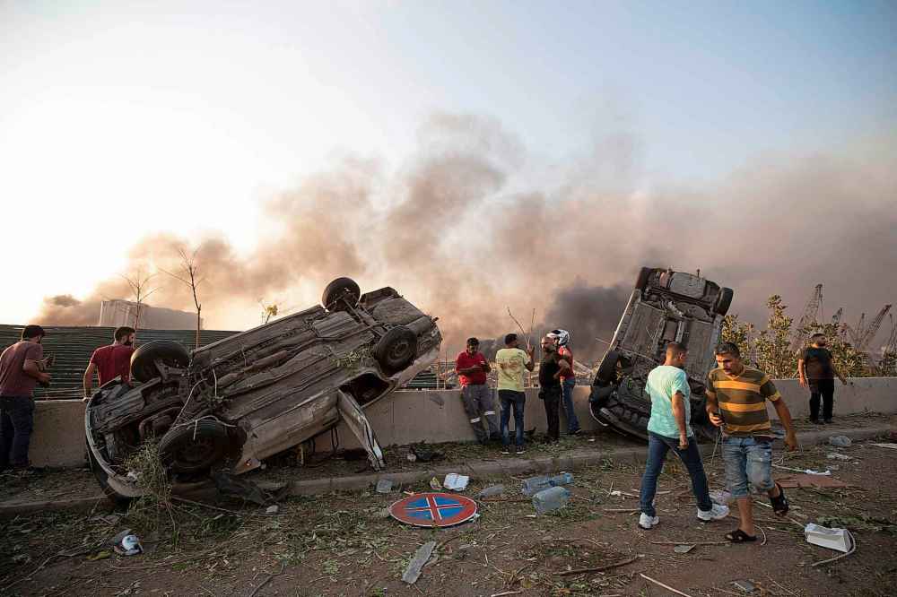 Massive explosions rocked downtown Beirut on Tuesday, flattening much of the port, damaging buildings and blowing out windows and doors as a giant mushroom cloud rose above the capital. (AP Photo/Hassan Ammar)