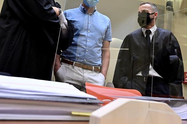 At the beginning of the trial against him on suspicion of violation of the drug and doping laws, defendant Mark Schmidt, center, stands between his lawyers Yuri Goldstein, left, and Alexander Dann, right, in Munich, Germany, Wednesday, Sept. 16, 2020. Schmidt and one of his alleged accomplices have been in custody for more than 18 months following police raids in the central German city of Erfurt, and at the Nordic skiing world championships in Innsbruck and Seefeld, Austria in February 2019. Blood bags were reportedly seized in the raids. (Peter Kneffel/Pool via AP)