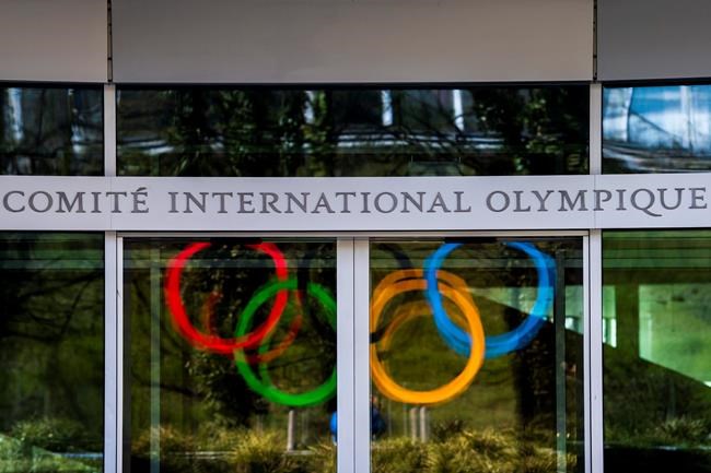 The Olympic Rings are displayed at the entrance of the IOC, International Olympic Committee headquarters during the coronavirus disease (COVID-19) outbreak in Lausanne, Switzerland, Tuesday, March 24, 2020. (Jean-Christophe Bott/Keystone via AP)