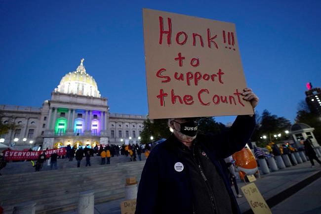 Keith Bentz joins others demonstrating outside the Pennsylvania State Capitol to urge that all votes be counted, Wednesday, Nov. 4, 2020, in Harrisburg, Pa., following Tuesday's election. (AP Photo/Julio Cortez)