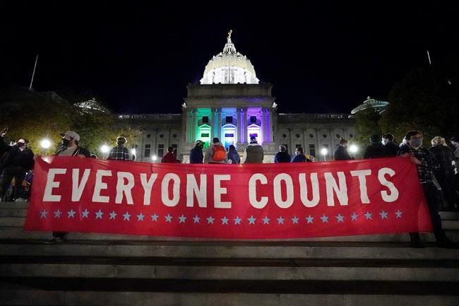 People demonstrate outside the Pennsylvania State Capitol to urge that all votes be counted, Wednesday, Nov. 4, 2020, in Harrisburg, Pa., following Tuesday's election. (AP Photo/Julio Cortez)