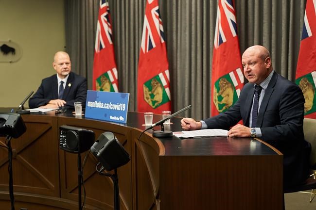 Manitoba Education Minister Kelvin Goertzen, left, and Manitoba chief provincial public health officer Dr. Brent Roussin speak at a media news conference at the Manitoba Legislative Building, in Winnipeg, Thursday, Aug. 13, 2020. THE CANADIAN PRESS/David Lipnowski