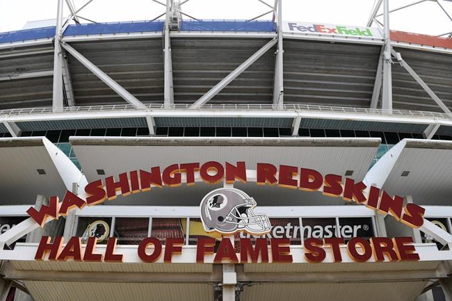 Signs for the Washington Redskins are displayed outside FedEx Field in Landover, Md., Monday, July 13, 2020. The Washington NFL franchise announced Monday that it will drop the